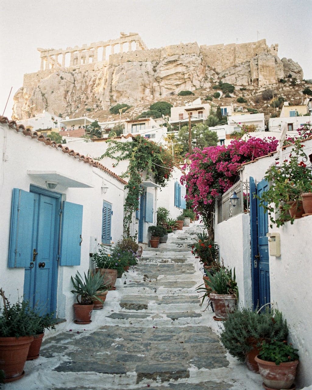 Whitewashed houses, steps and bougainvillea in Anafiotika on the north slope of the Acropolis in morning light